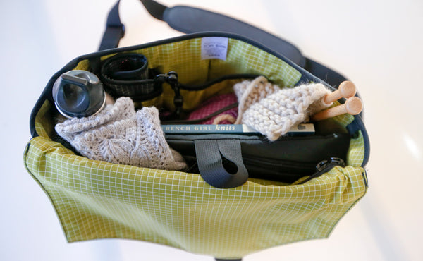 A Maker's Bag filled with knitting and tools.